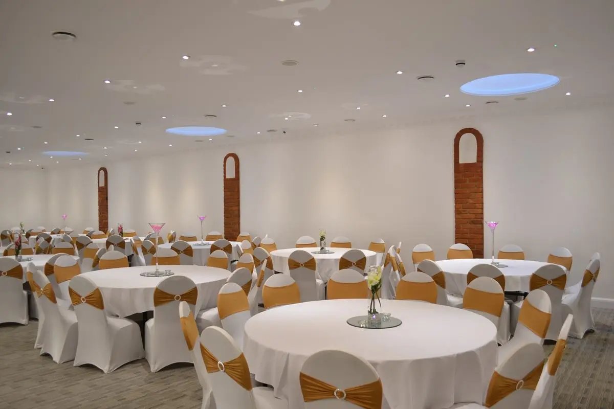 Main Hall in The Atrium London, elegant event space with round tables for gatherings.