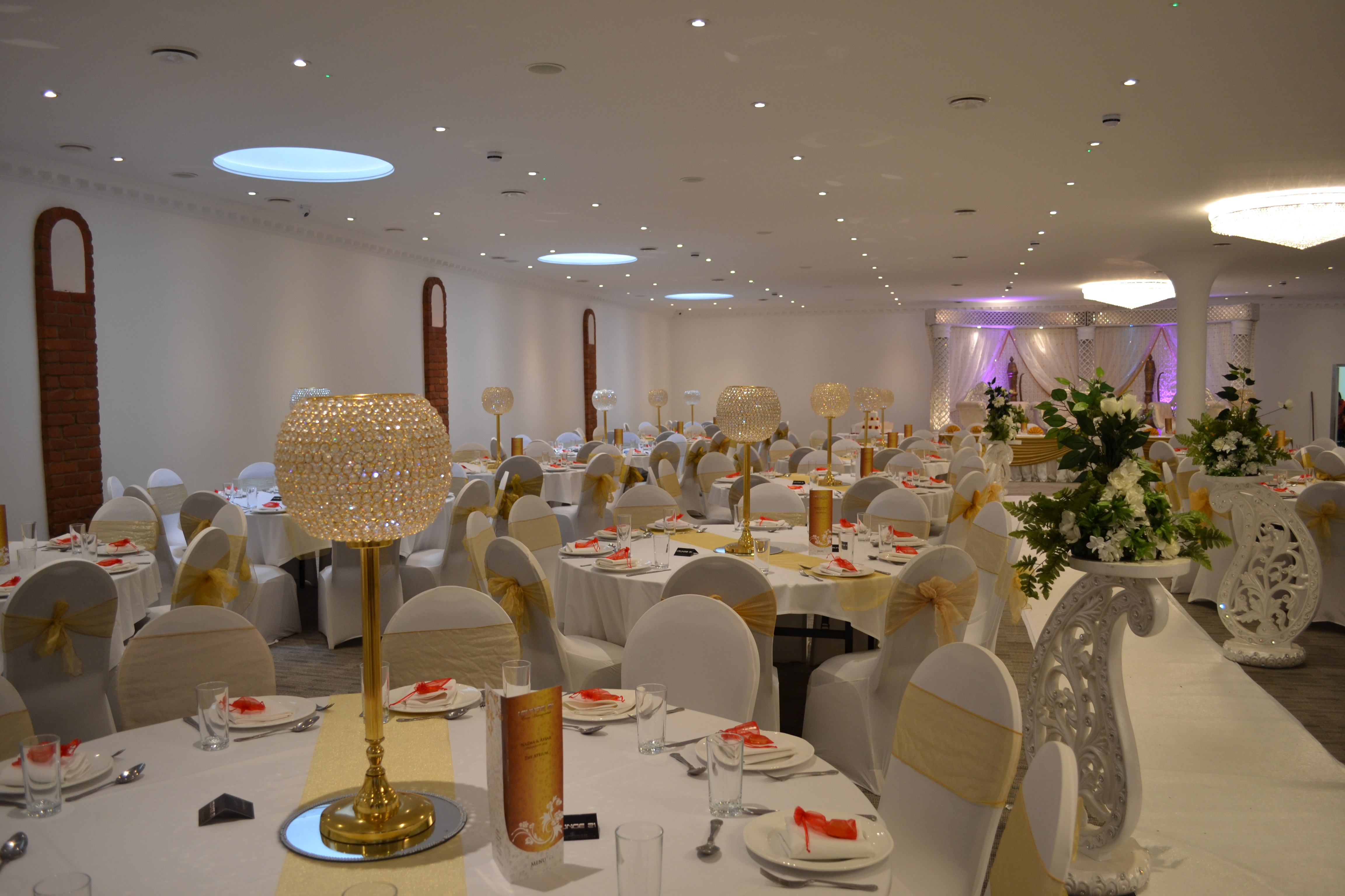 Main Hall in The Atrium London, elegant wedding venue with gold-accented table settings.