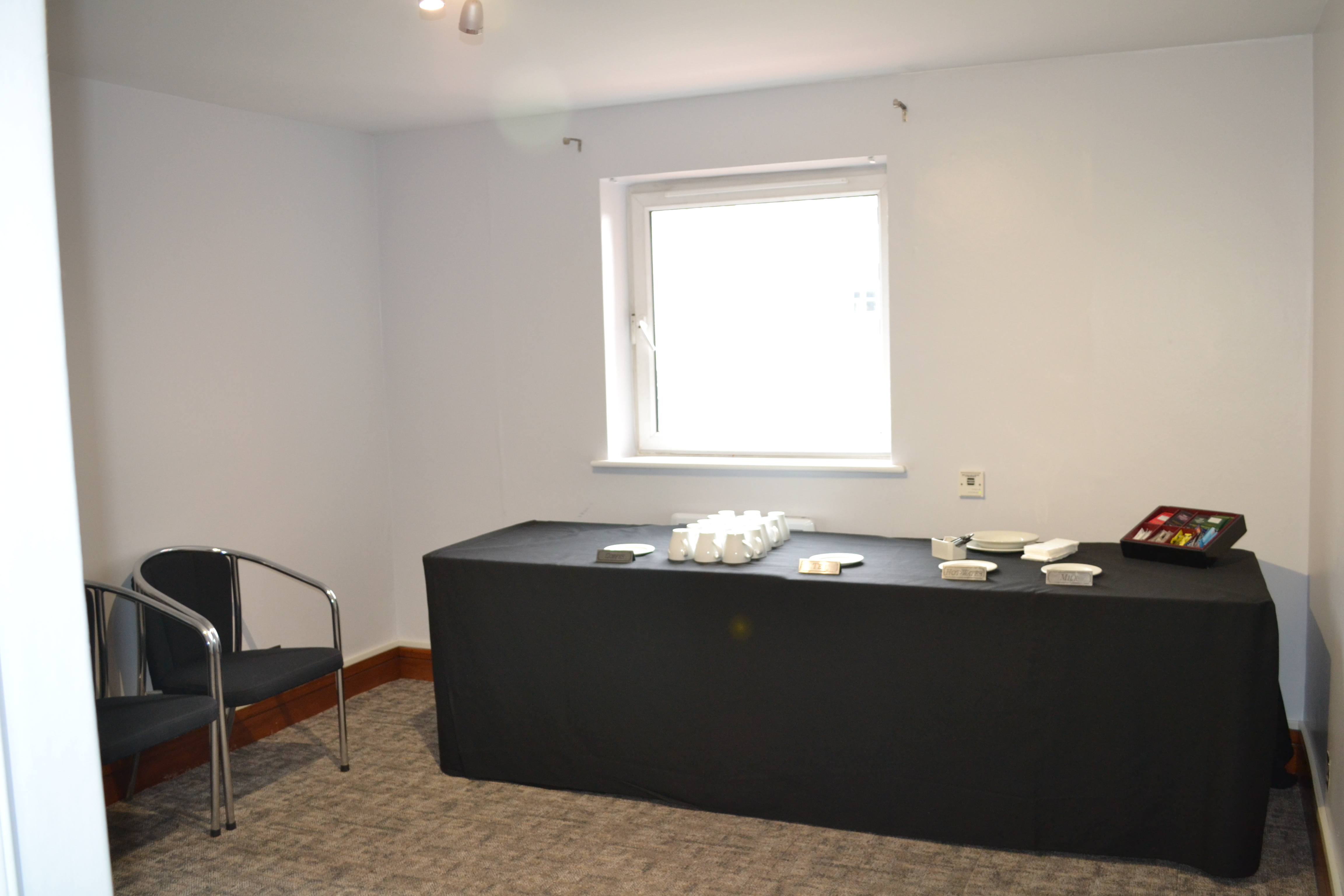 Adamson Suite meeting space with black table, ideal for conferences and workshops.