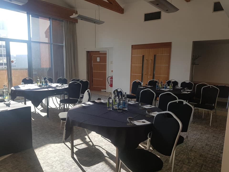 Edgerton Suite meeting room with round tables, ideal for conferences and workshops.