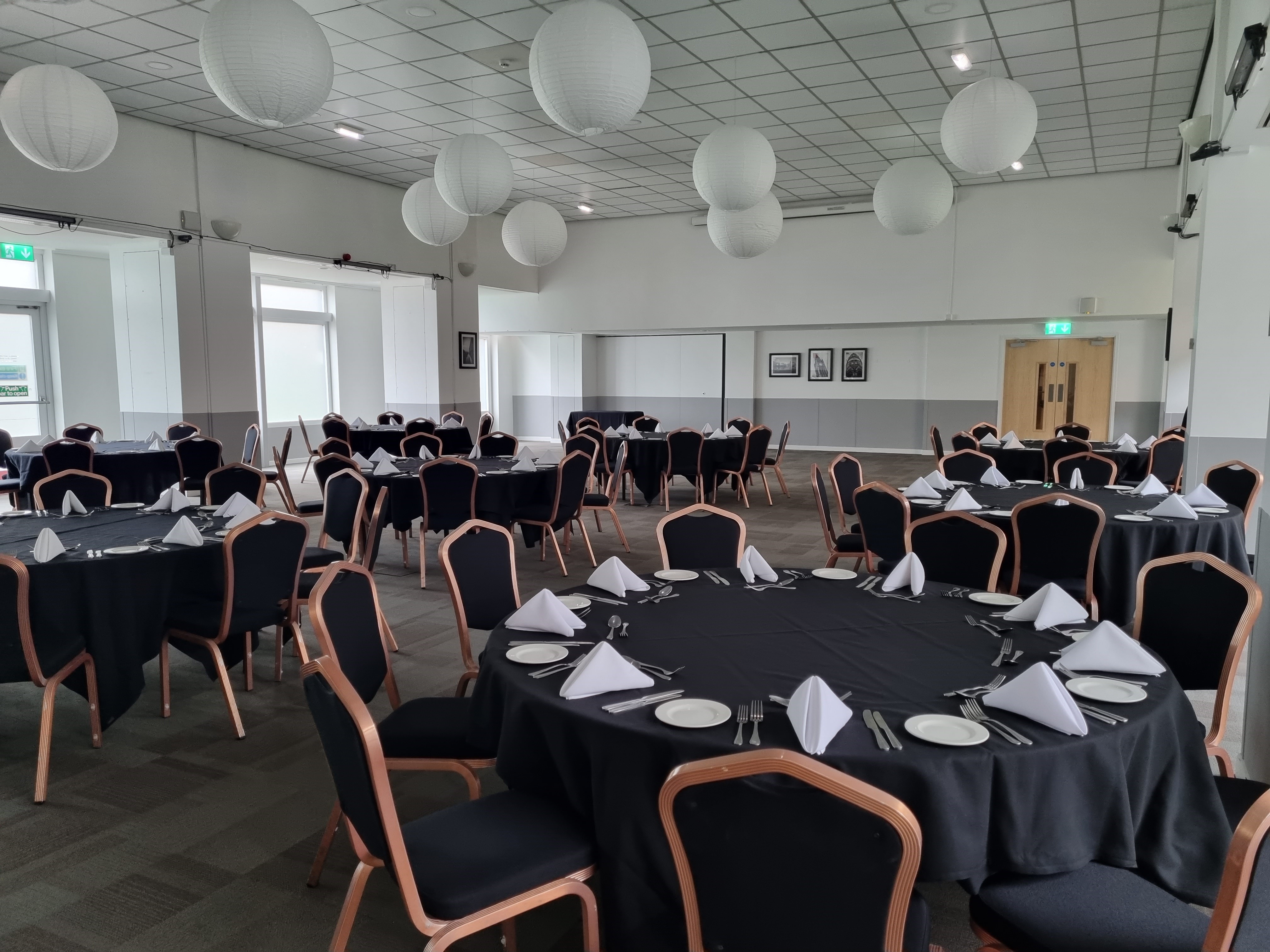 Pioneer Room at Manchester Conference Centre, elegant event space with round tables.