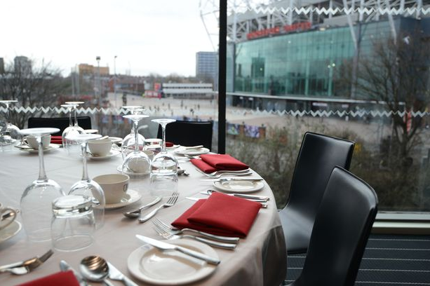Elegant dining setup at Hotel Football's Stadium Suite for corporate events.