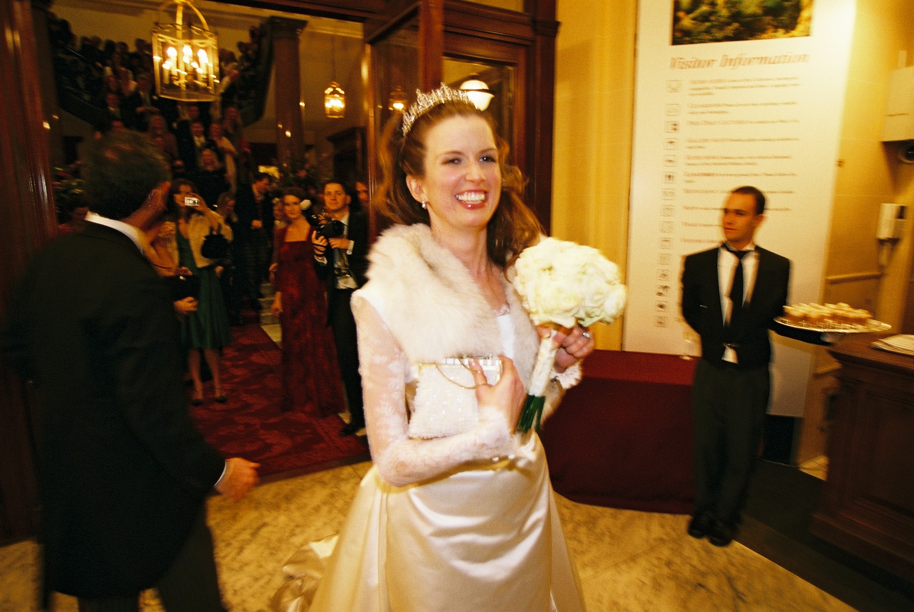 Joyful bride with bouquet in elegant wedding venue at The Wallace Collection.
