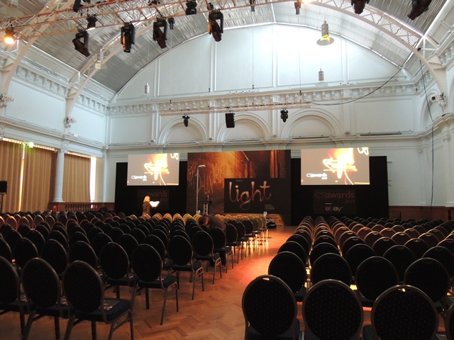 Lindley Hall conference setup with black chairs and stage for impactful presentations.