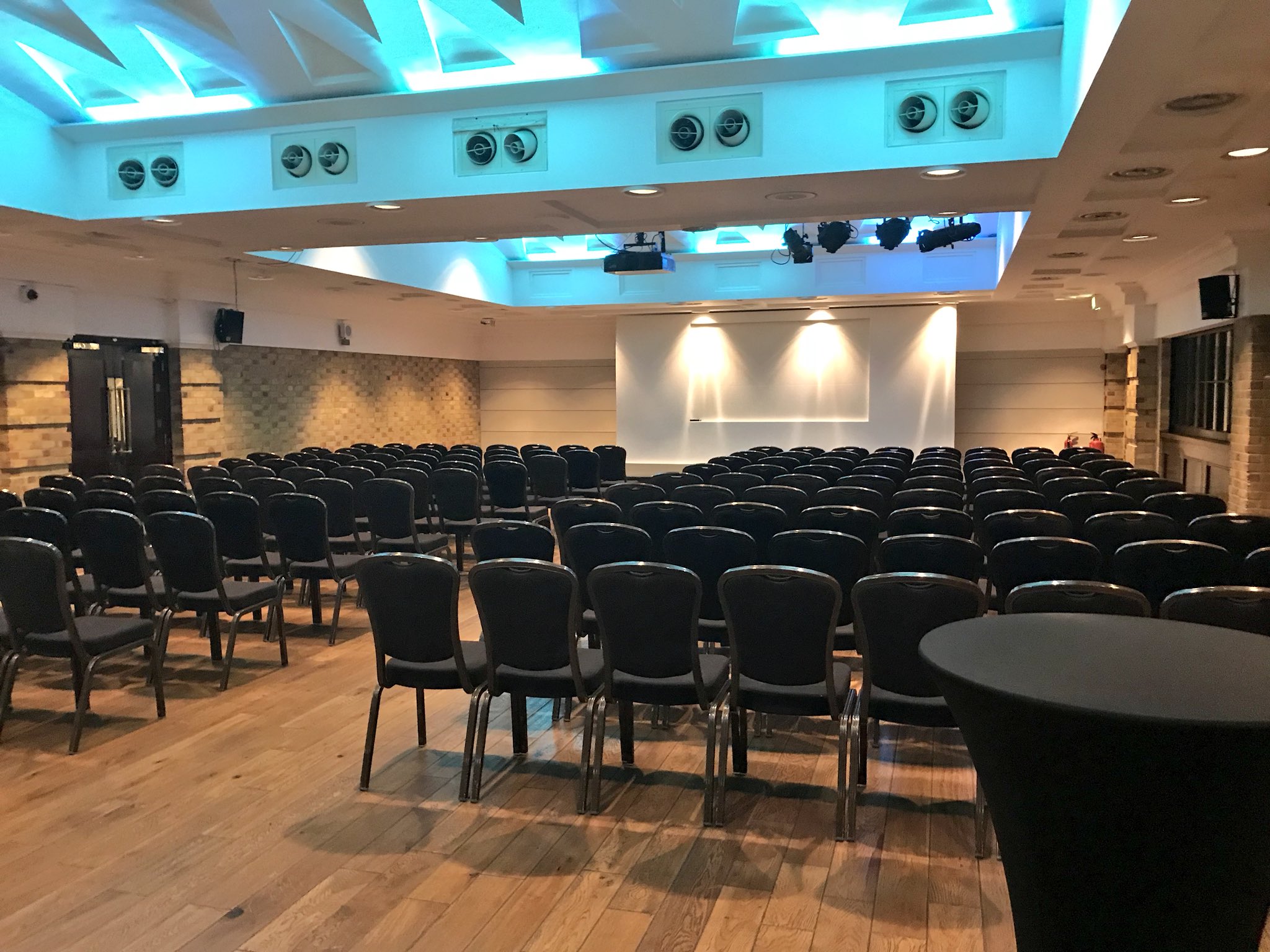 Spacious Queen Charlotte venue with black chairs, ideal for conferences and seminars.