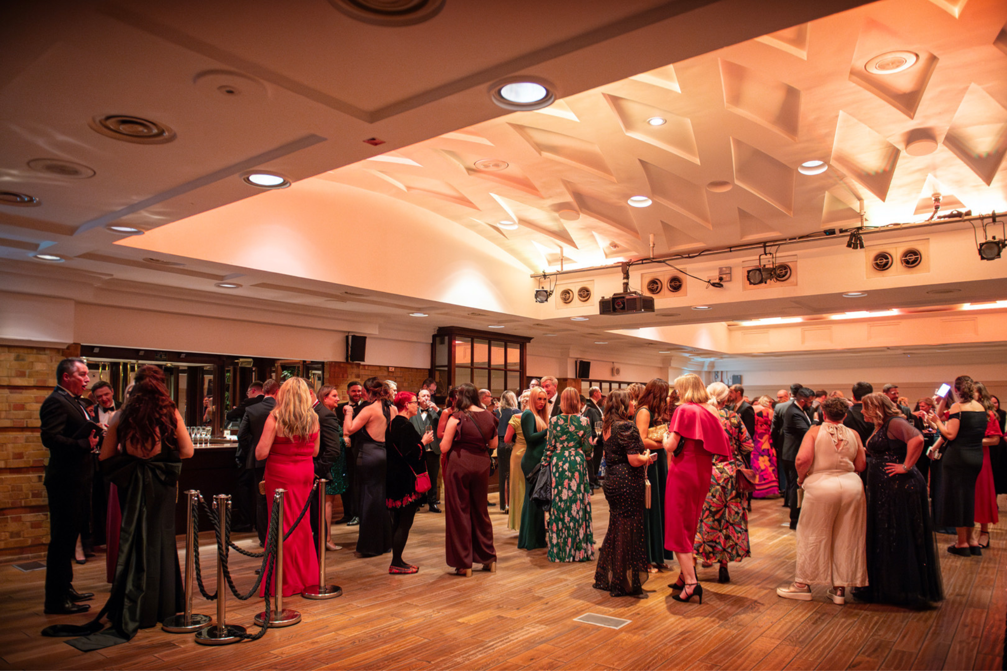 Elegant event at The Queen Charlotte, featuring warm lighting and networking attendees.