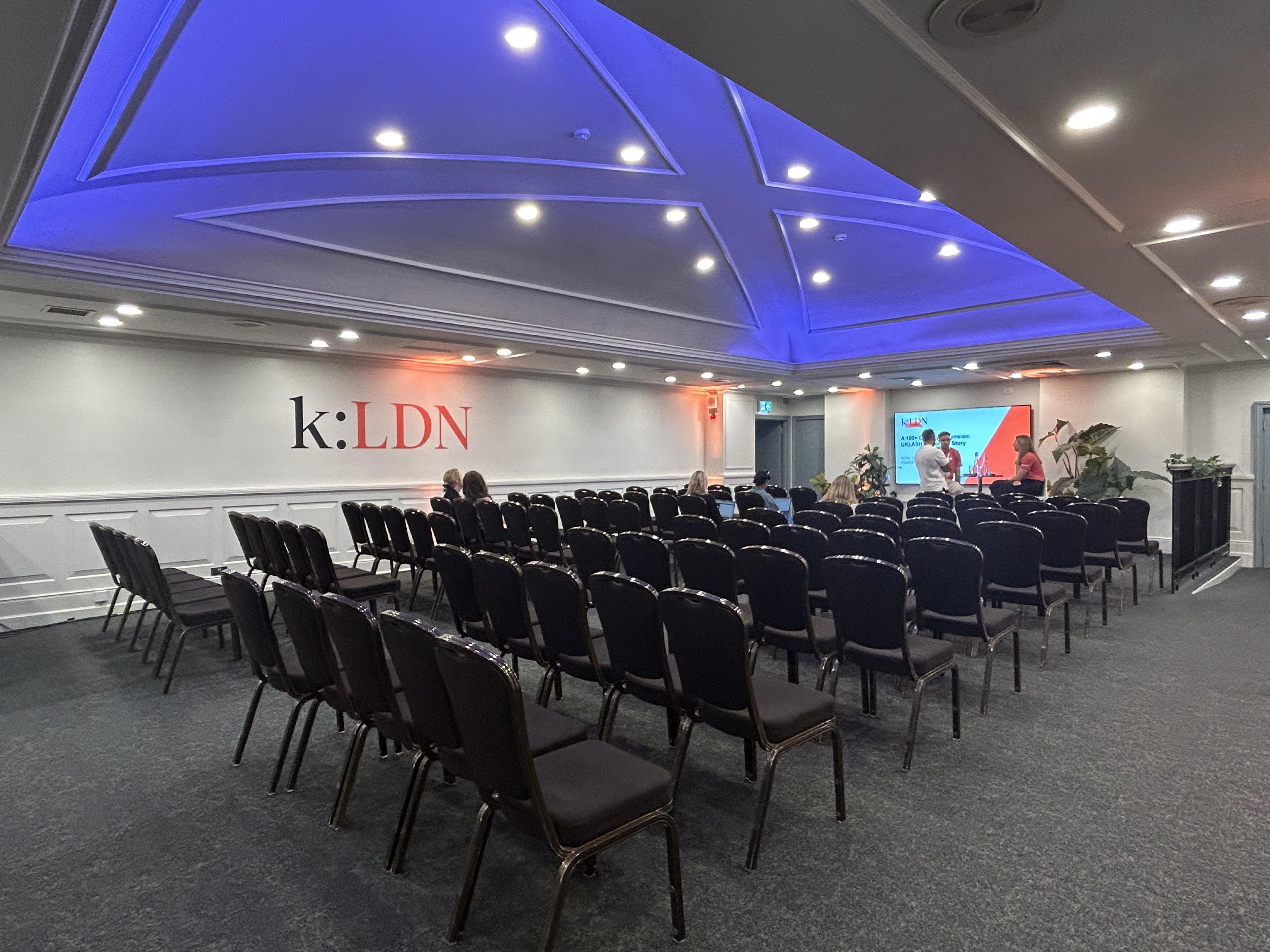 Event space at The James Watt with black chairs and modern lighting for presentations.