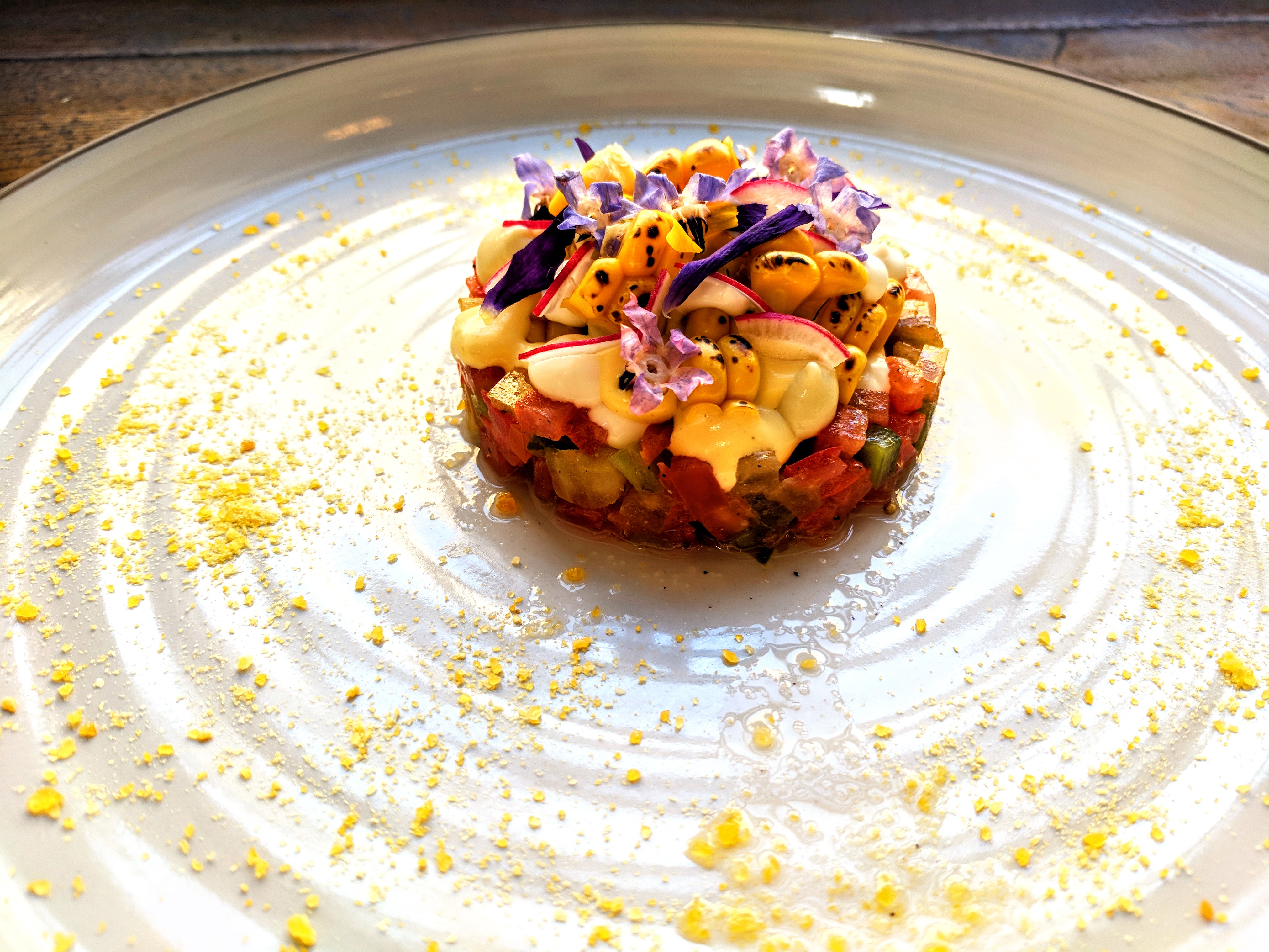 Elegant dish with edible flowers at The James Watt, perfect for upscale dining events.