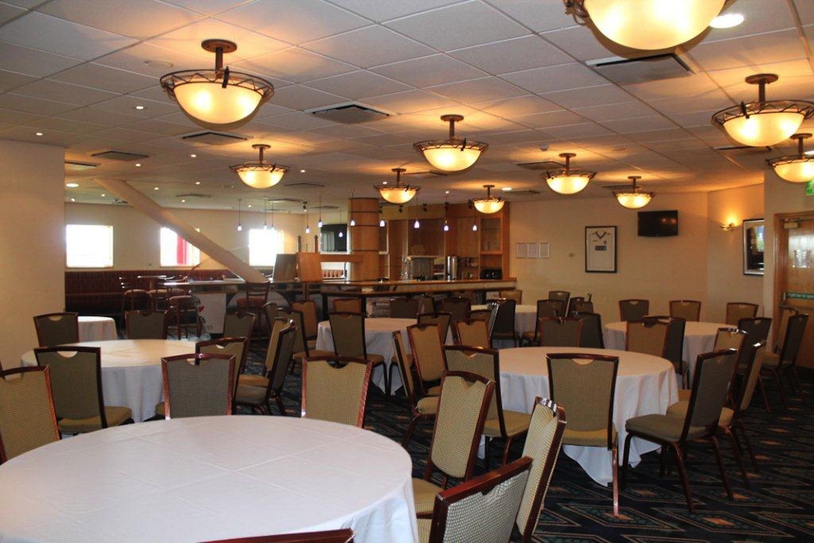 Macron Suite at Bolton Whites Hotel with round tables, perfect for events and meetings.