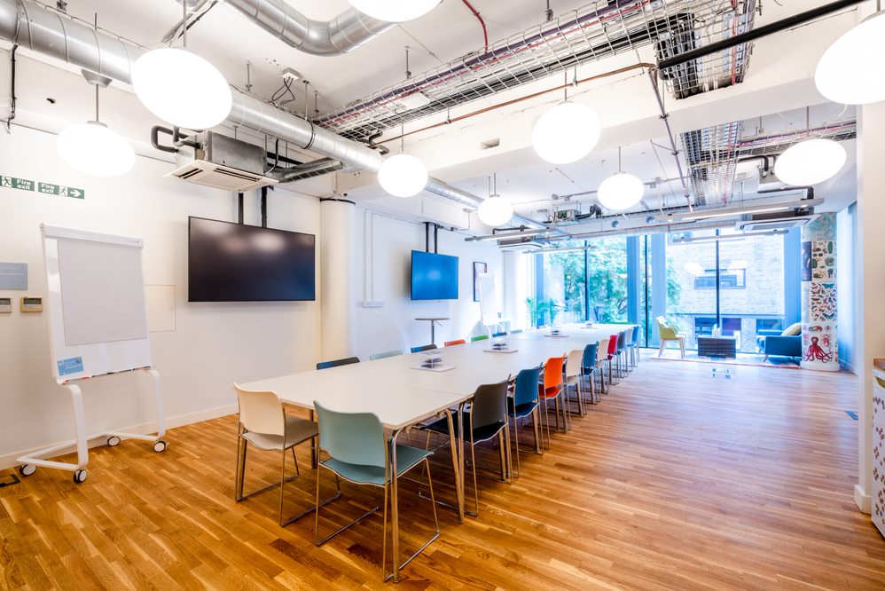 Modern meeting room at Wallacespace Clerkenwell with colorful chairs for workshops.