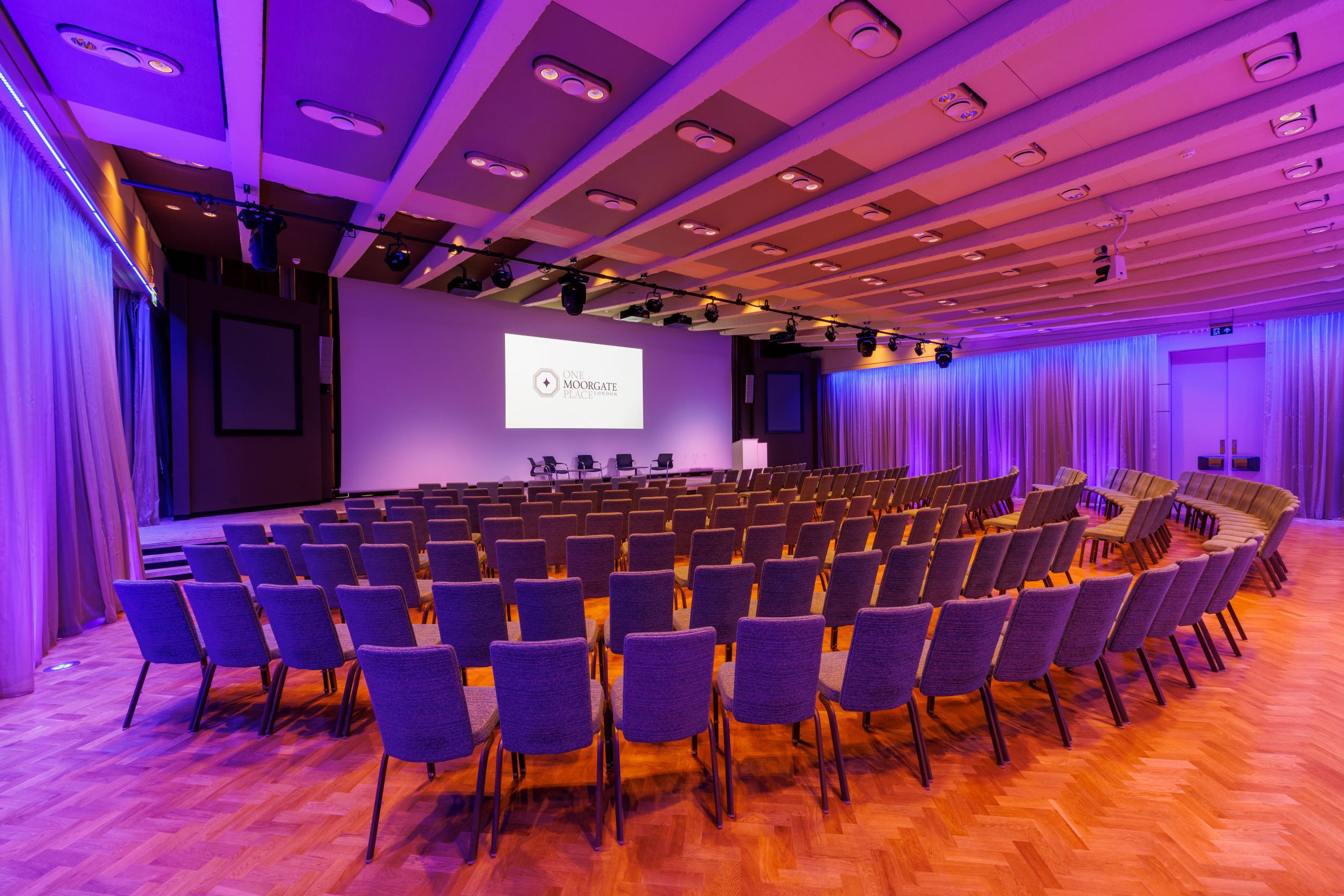 Great Hall at One Moorgate Place, purple-lit conference room for events and presentations.