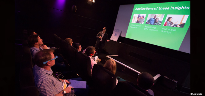 Engaging speaker presenting to attentive audience in Rich Mix theater setting.