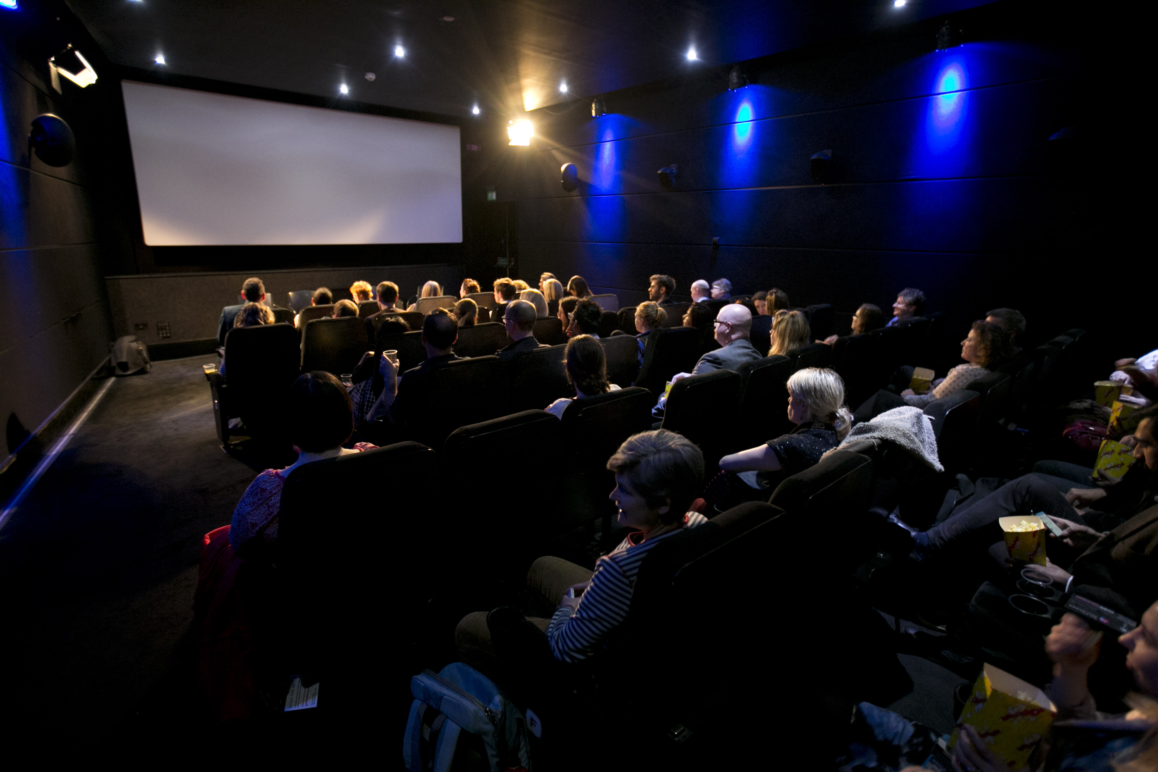 Cozy theater screening event with engaged audience in comfortable chairs at Rich Mix.