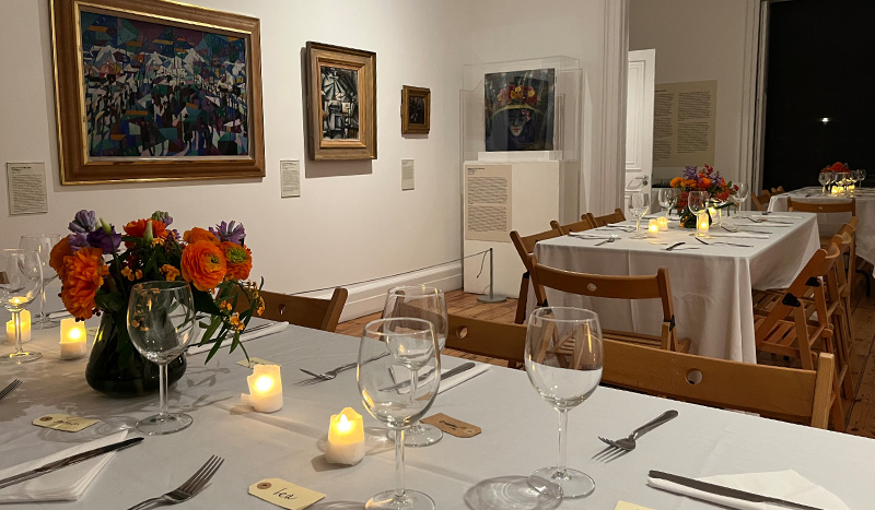 Elegant dining area with floral centerpieces in Estorick Collection for sophisticated events.