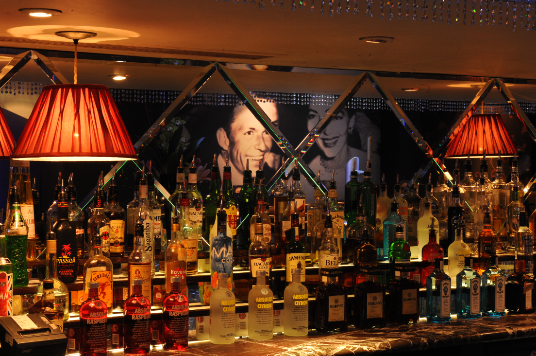 Stylish bar setup with colorful liquor bottles at Ruby Blue for networking events.