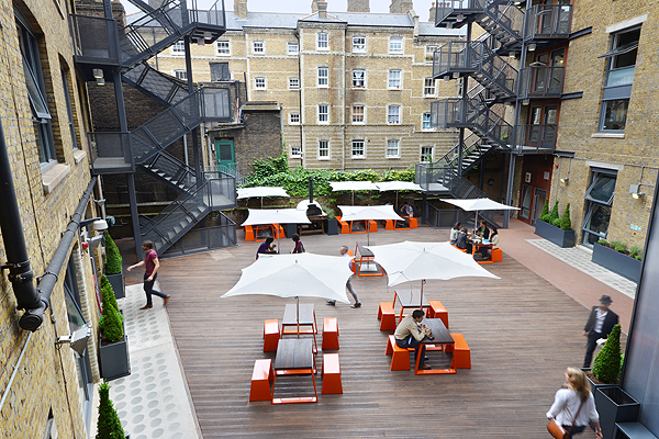 Versatile outdoor networking space with modern seating and greenery in Clerkenwell.