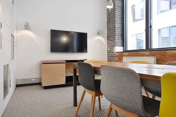 Modern meeting room with colorful chairs, ideal for collaborative events and presentations.