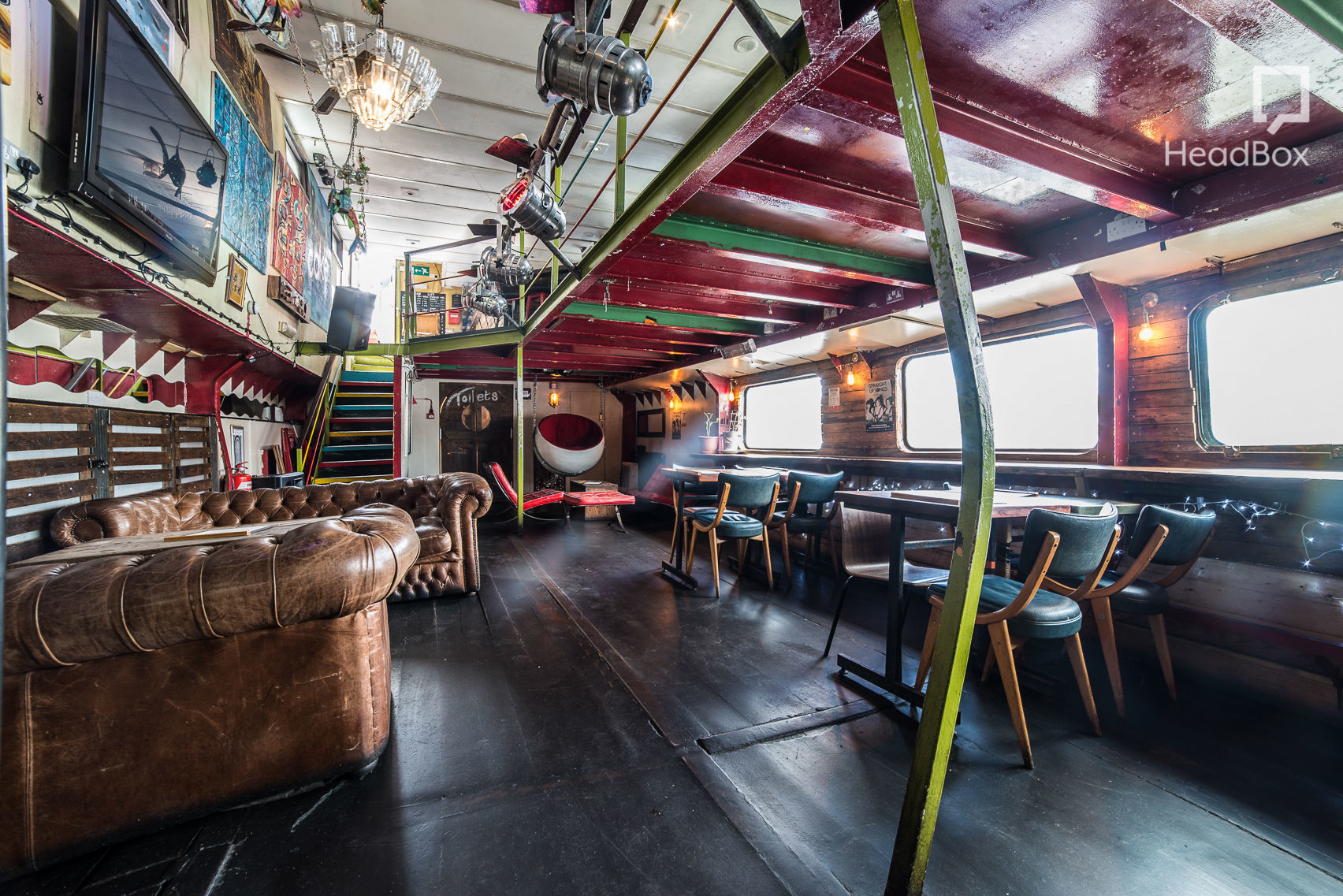 Eclectic event space at Tamesis Dock with vibrant decor for gatherings and meetings.