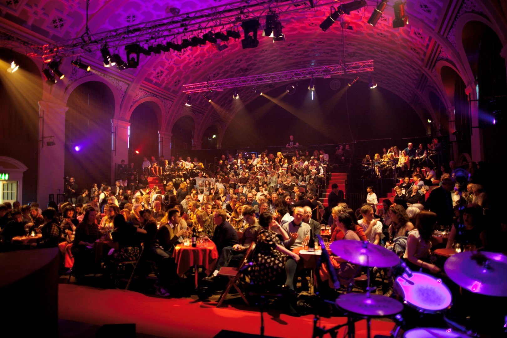 Grand Hall at Battersea Arts Centre, vibrant gala event with elegant tables and dynamic lighting.