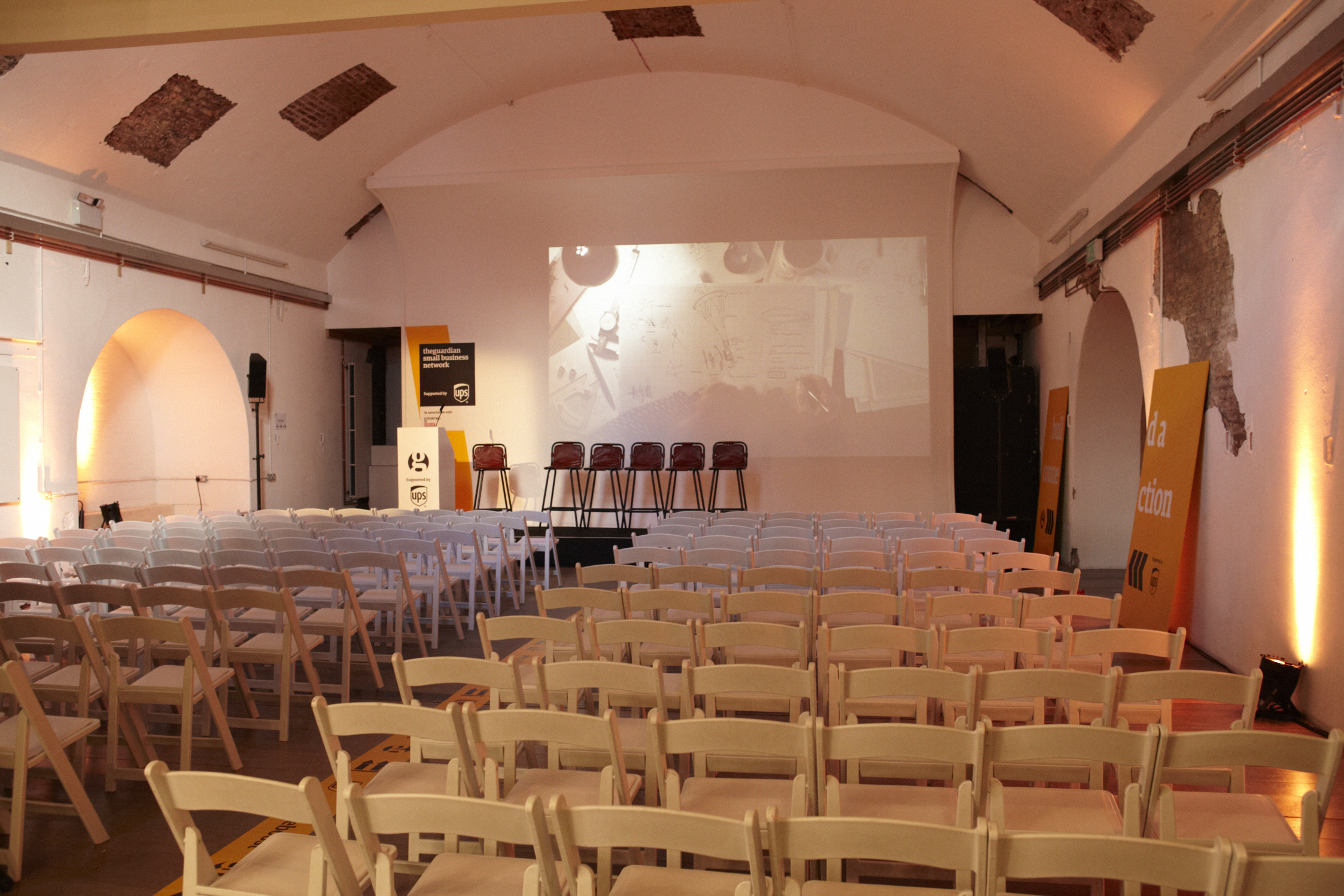 Event space in White Rabbit Shoreditch with white chairs, ideal for conferences and workshops.