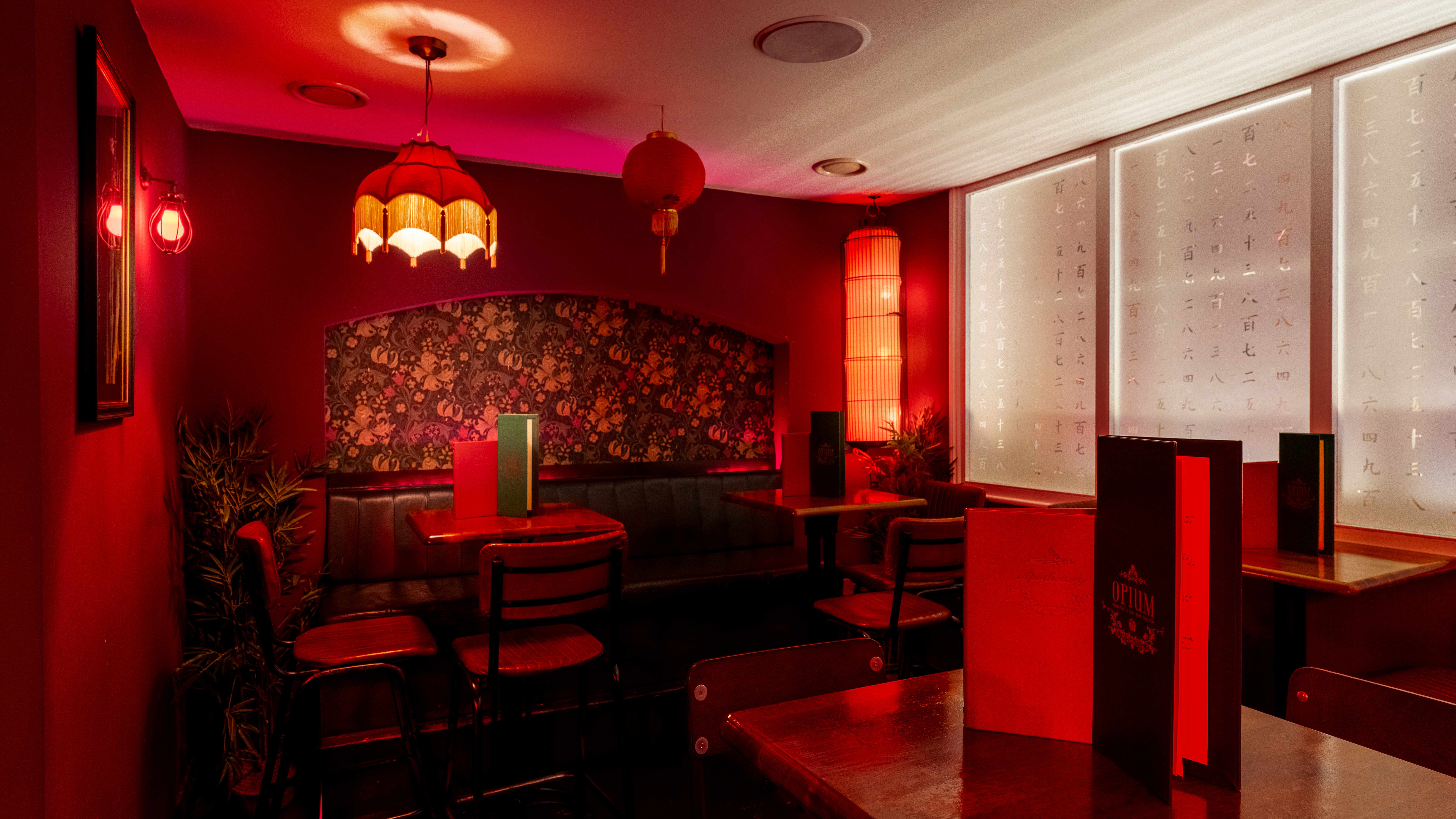 "Intimate Apothecary Bar with rich red tones, ideal for cocktail receptions and themed events."