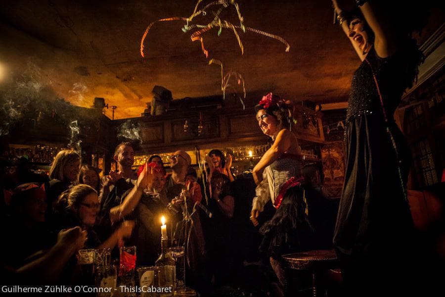 Cabaret performance at The George Tavern with atmospheric lighting for immersive event hosting.