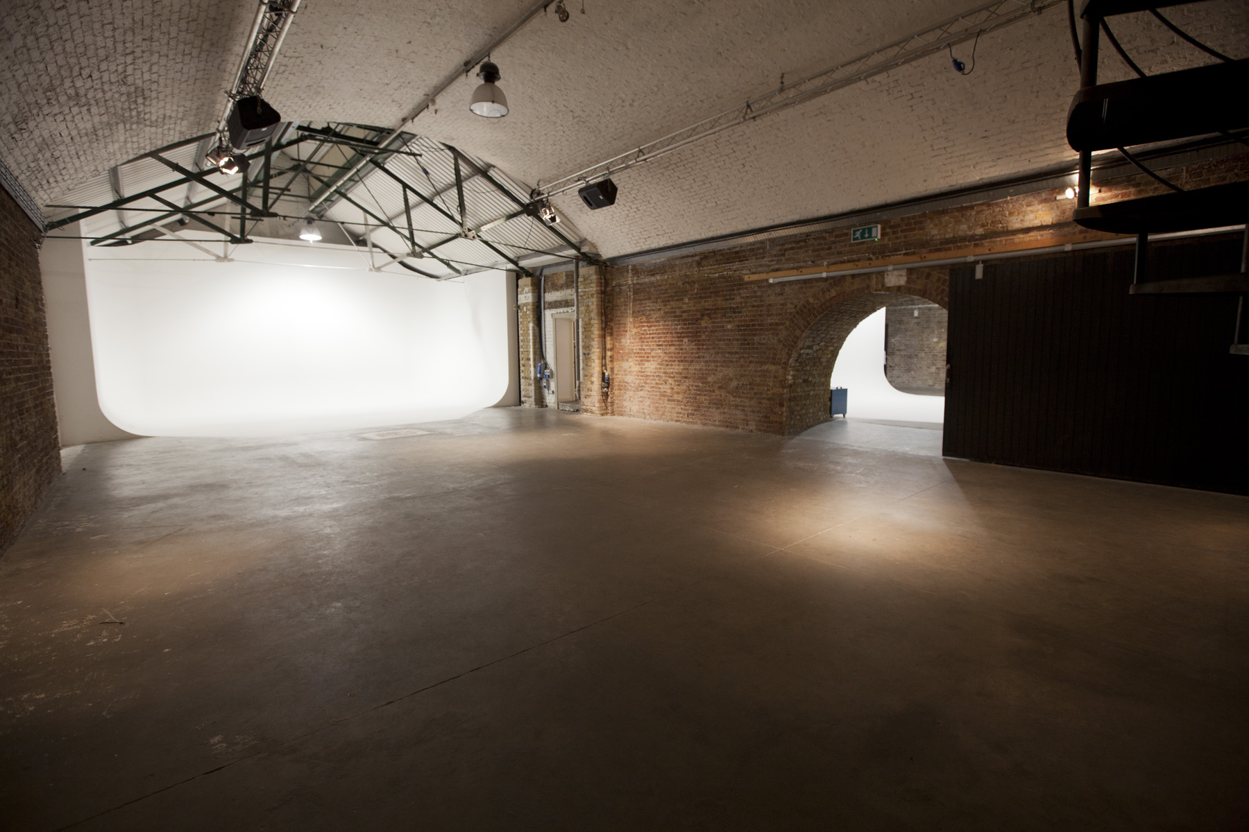 Versatile event space in Shoreditch Studios with exposed brick walls for corporate meetings.