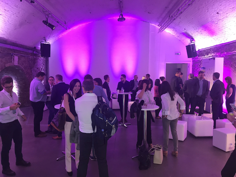 Vibrant networking event in Shoreditch Studios with modern furniture and dynamic lighting.