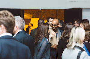 Networking event in Shoreditch Studios with attendees in formal attire.