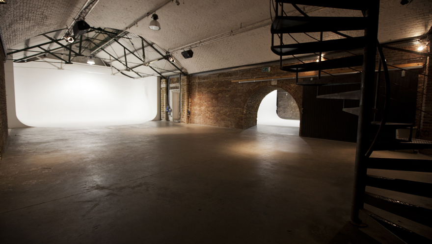 Versatile Shoreditch event space with exposed brick and spiral staircase for meetings and workshops.