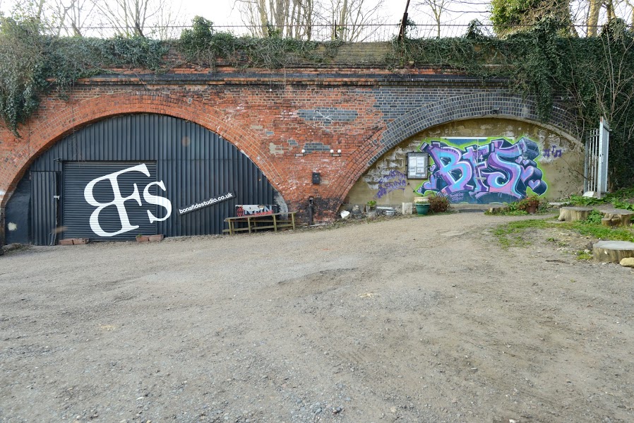 Industrial venue with exposed brick and graffiti art for creative events.