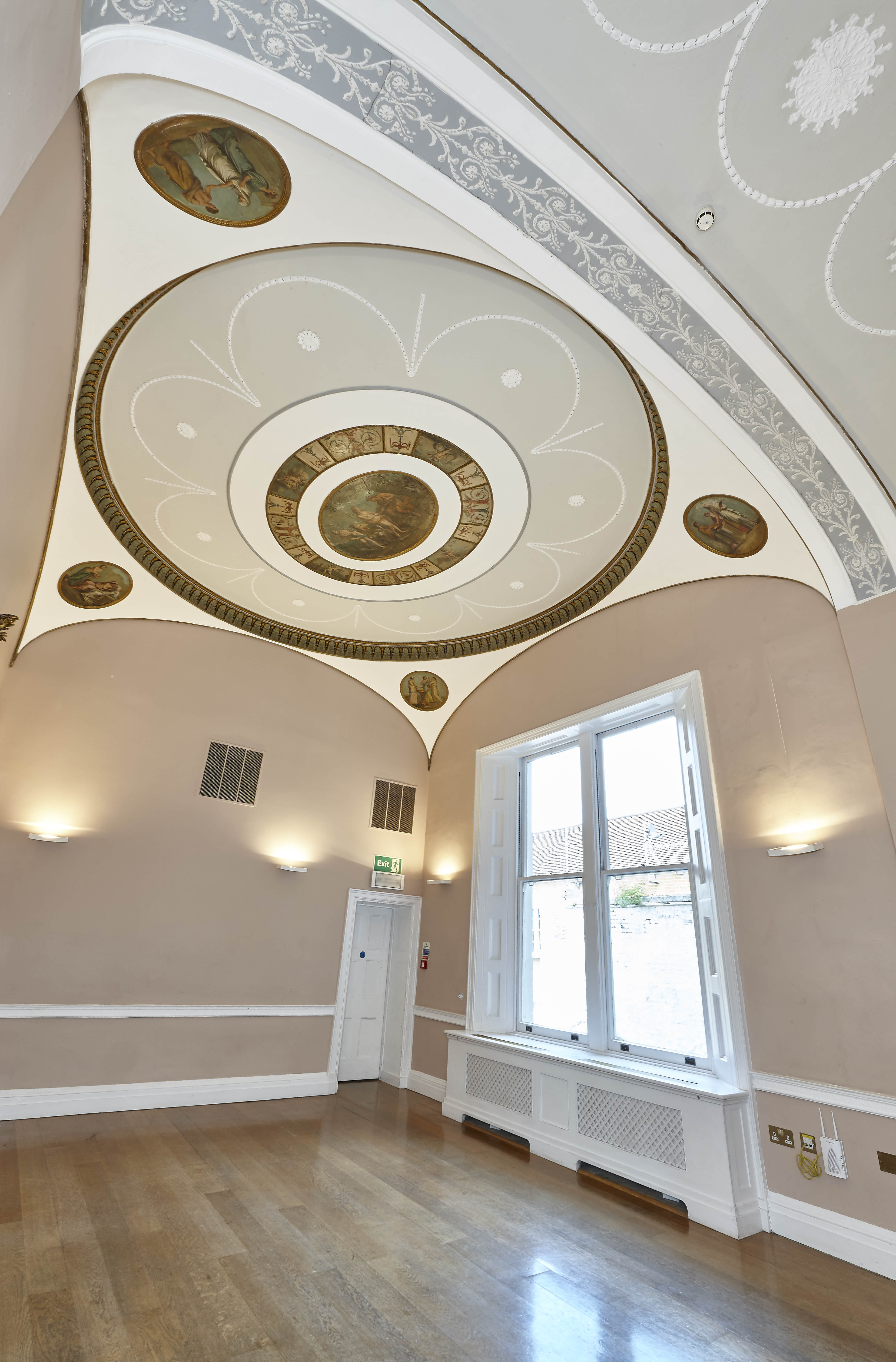Elegant meeting room with intricate ceiling, perfect for events and brainstorming sessions.
