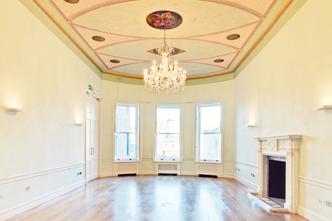 Elegant meeting room with high ceilings, ideal for formal events and gatherings.