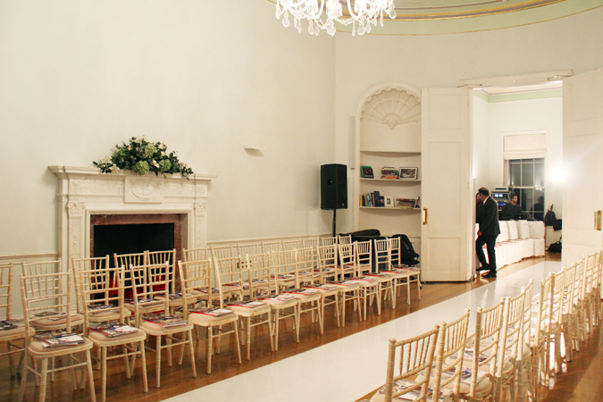 Elegant event space with gold chiavari chairs, perfect for meetings or presentations.