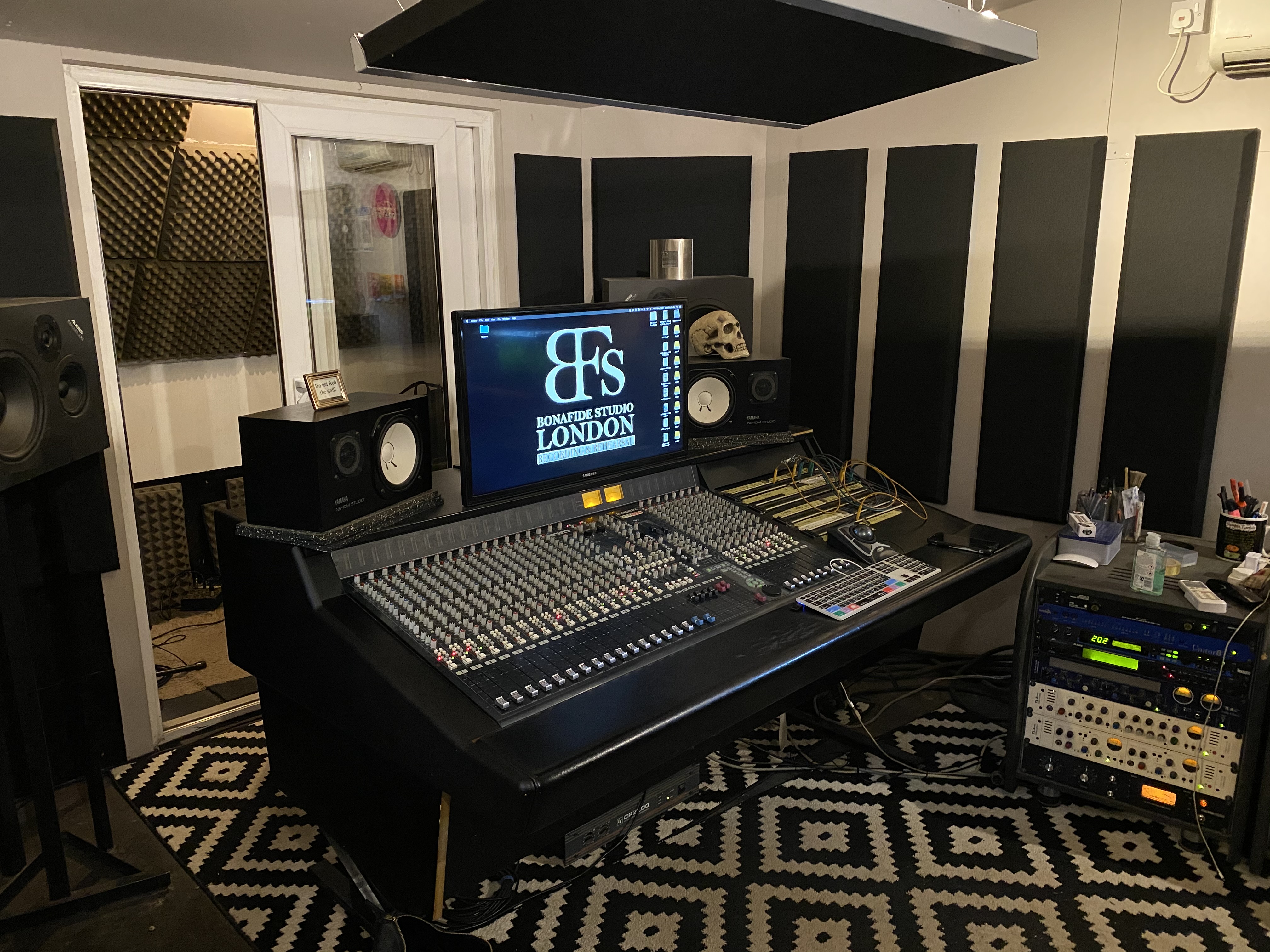 Professional audio recording studio with mixing console for music events and podcasts.