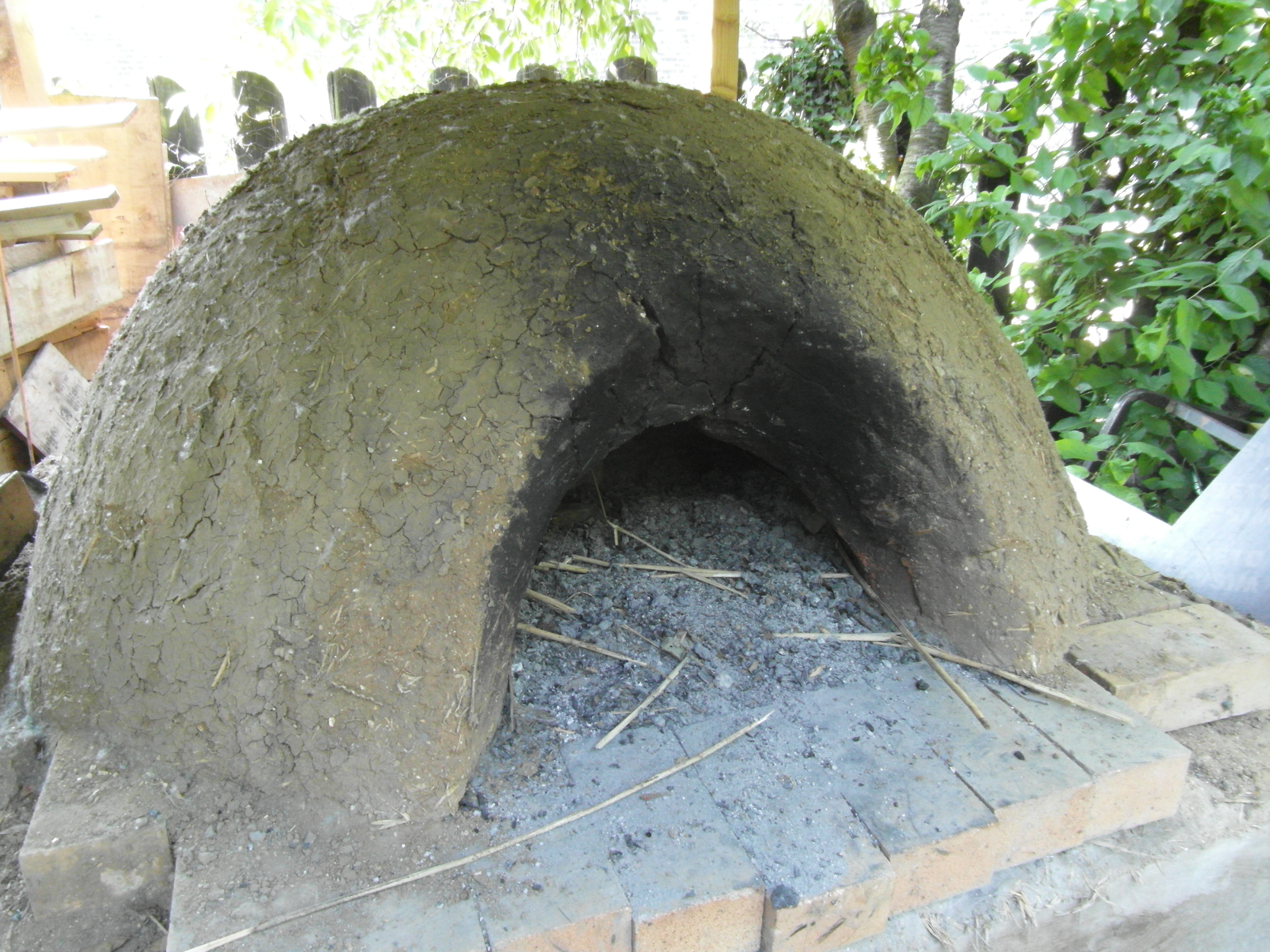 Outdoor kitchen with clay oven in Camley Street Park for team-building culinary events.