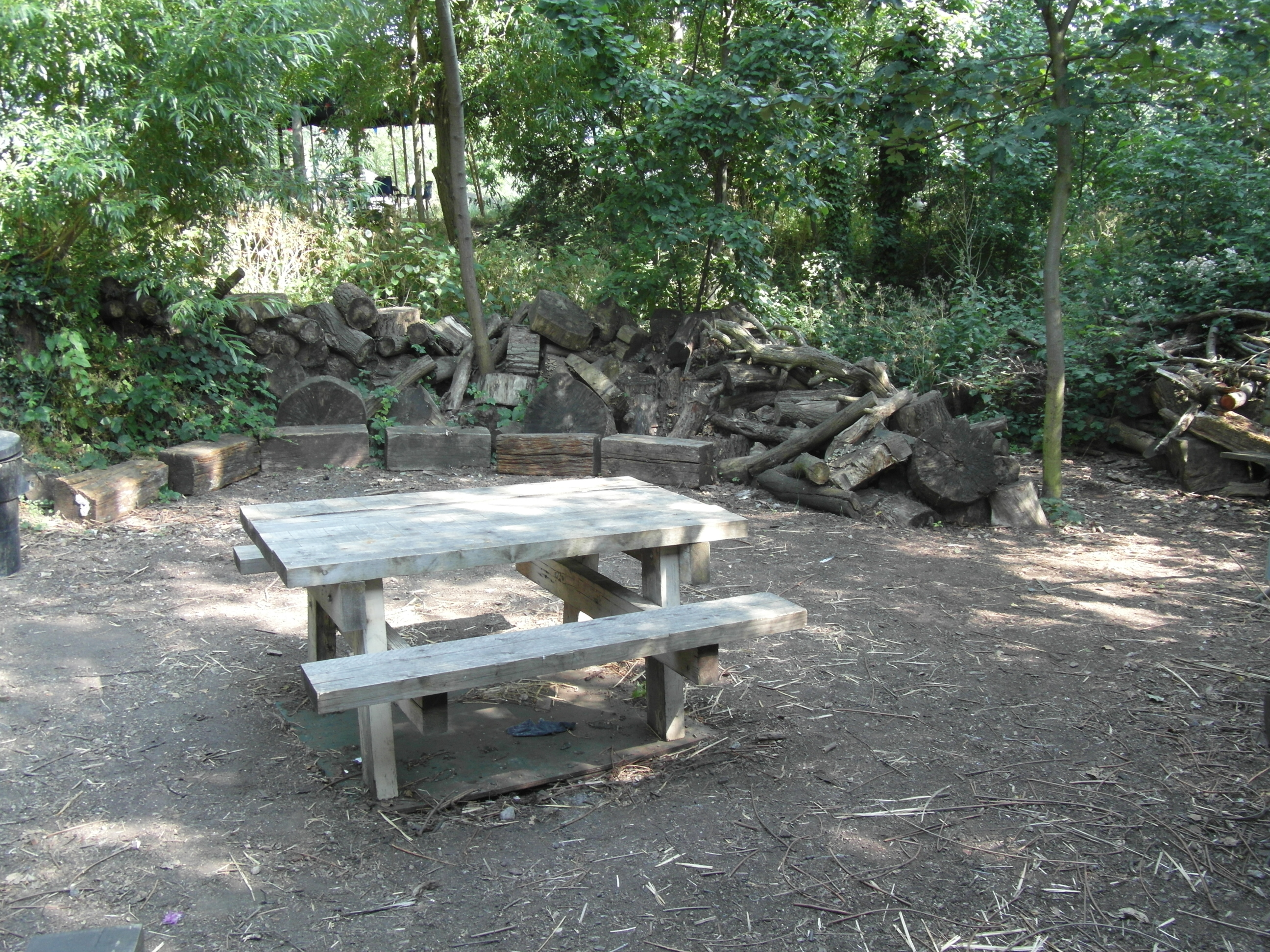Outdoor kitchen in Camley Street Park, rustic wooden table for team-building retreats.