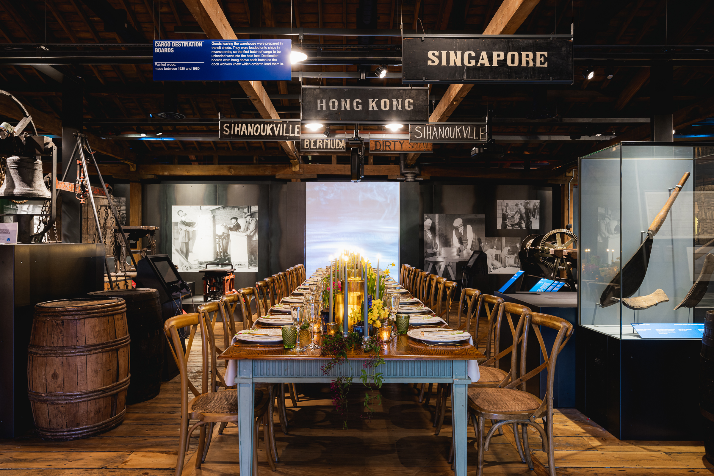 Long dining table with rustic decor at London Museum Docklands for corporate events.