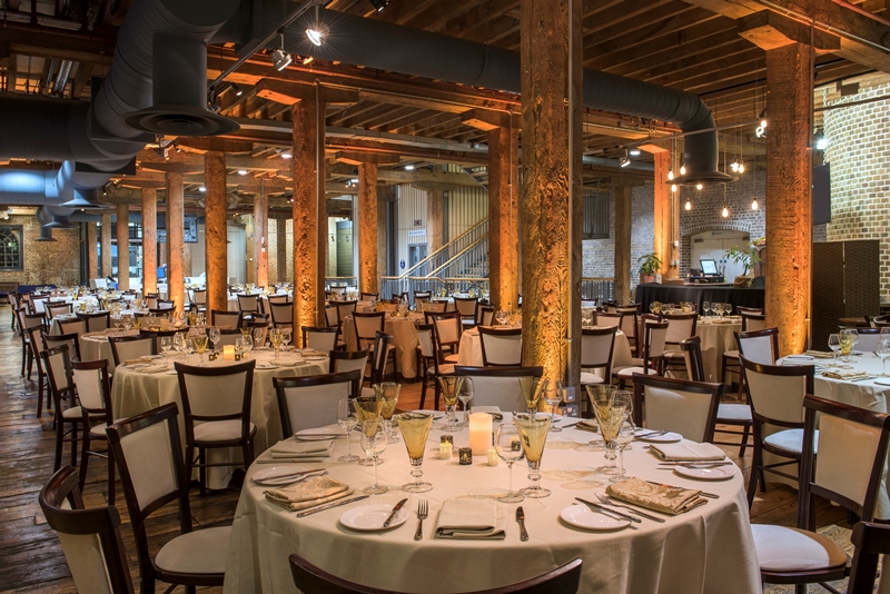 Muscovado Hall dining space with round tables, ideal for events in London Museum Docklands.