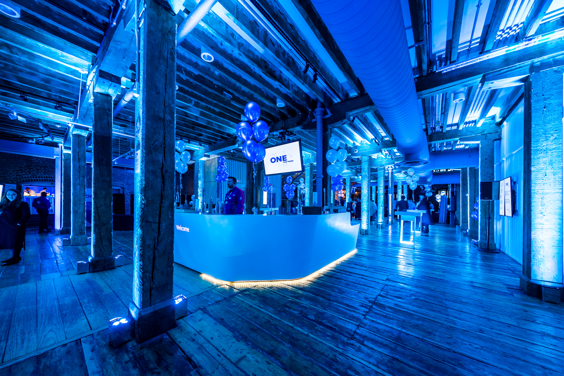 Muscovado Hall at London Museum Docklands, modern event space with blue lighting.
