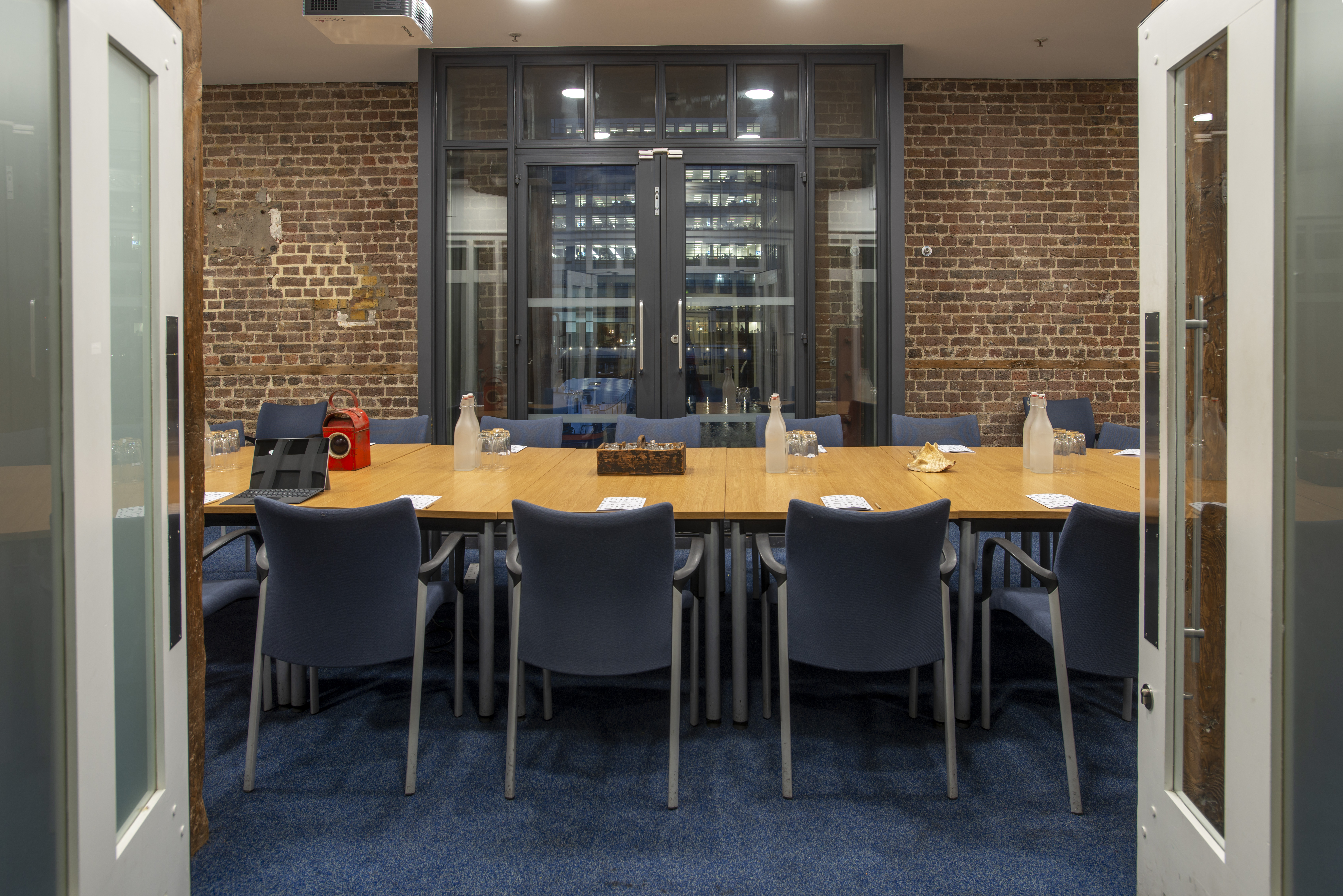Modern Docklands Boardroom with wooden table, ideal for meetings and brainstorming sessions.
