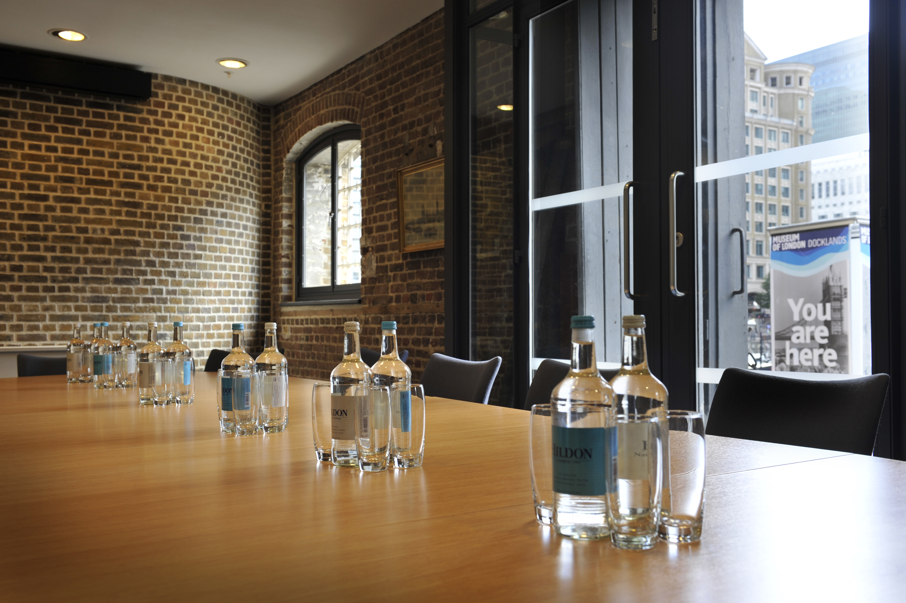Docklands Boardroom with wooden table, ideal for meetings and events in London.