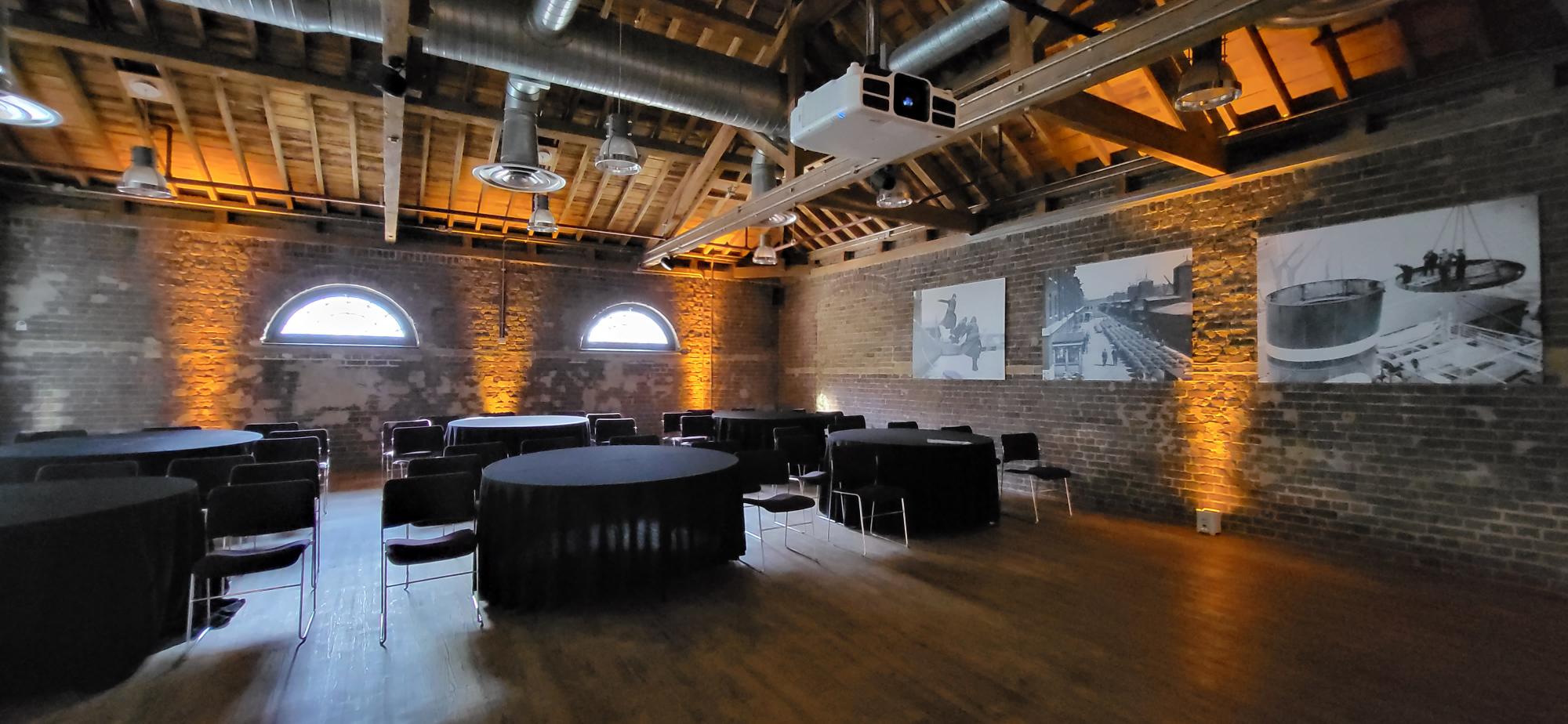 Quayside Room at London Museum Docklands, featuring exposed brick for events and meetings.