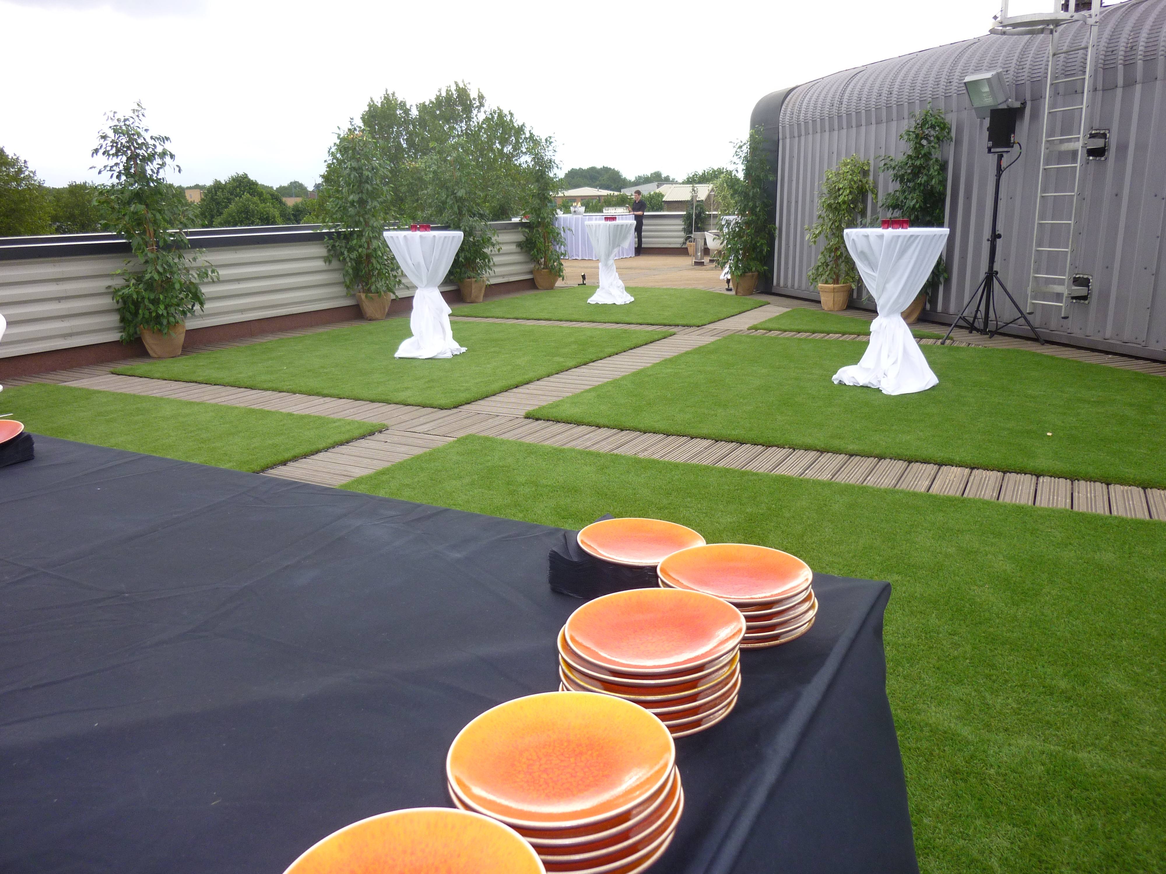 Smokehouse Gallery outdoor event space with cocktail tables, ideal for receptions and gatherings.