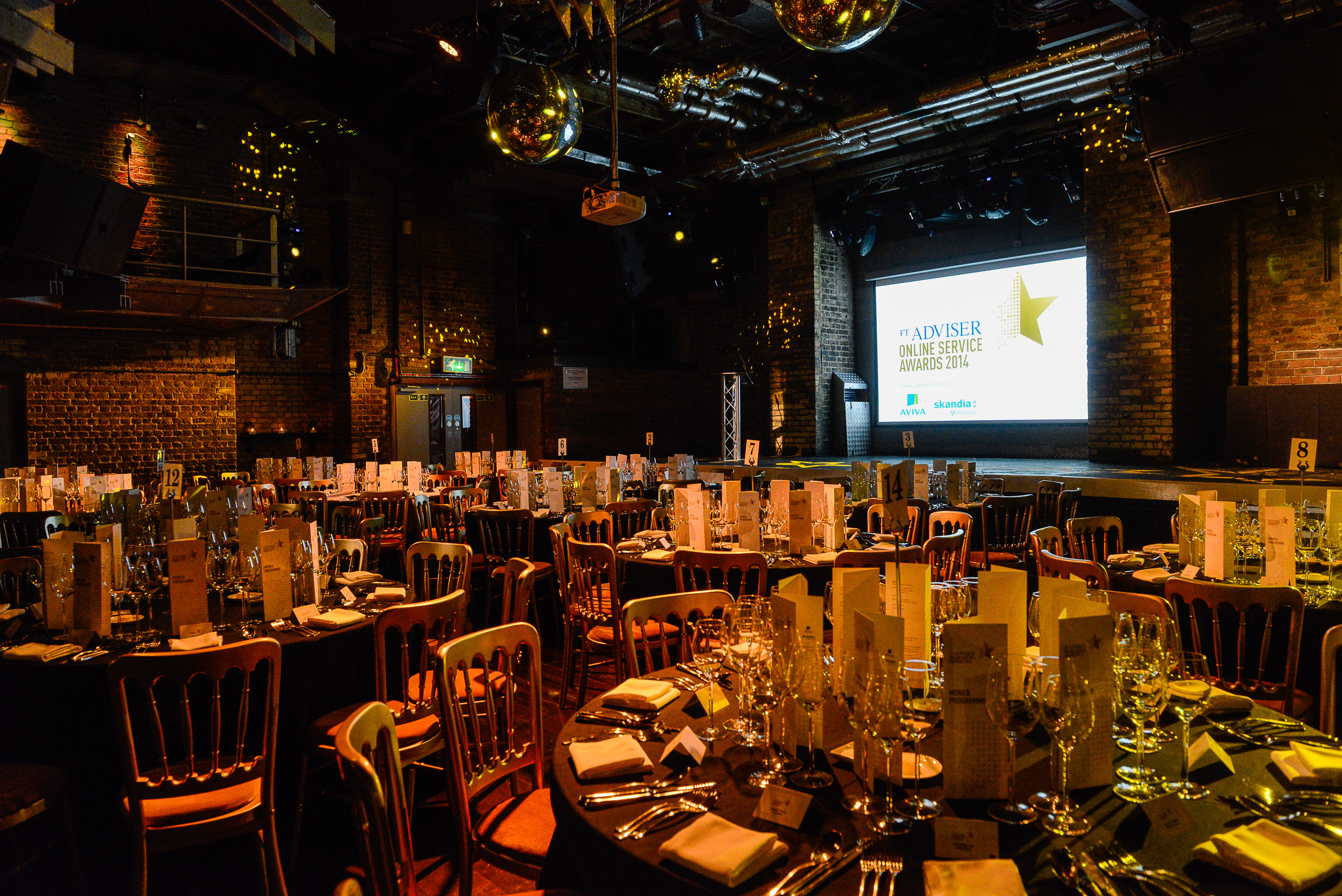 Elegant event space with round tables, perfect for formal dinners and awards ceremonies.