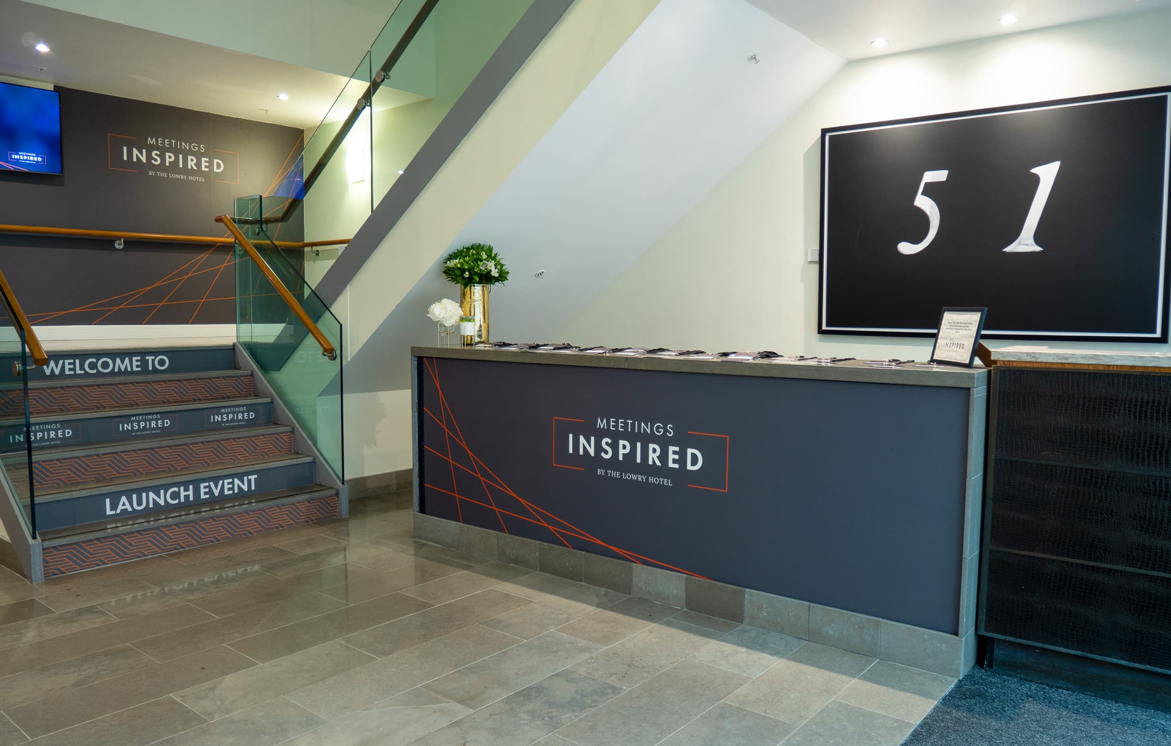 Modern branded registration area in The Lowry Hotel Grand Ballroom for corporate events.