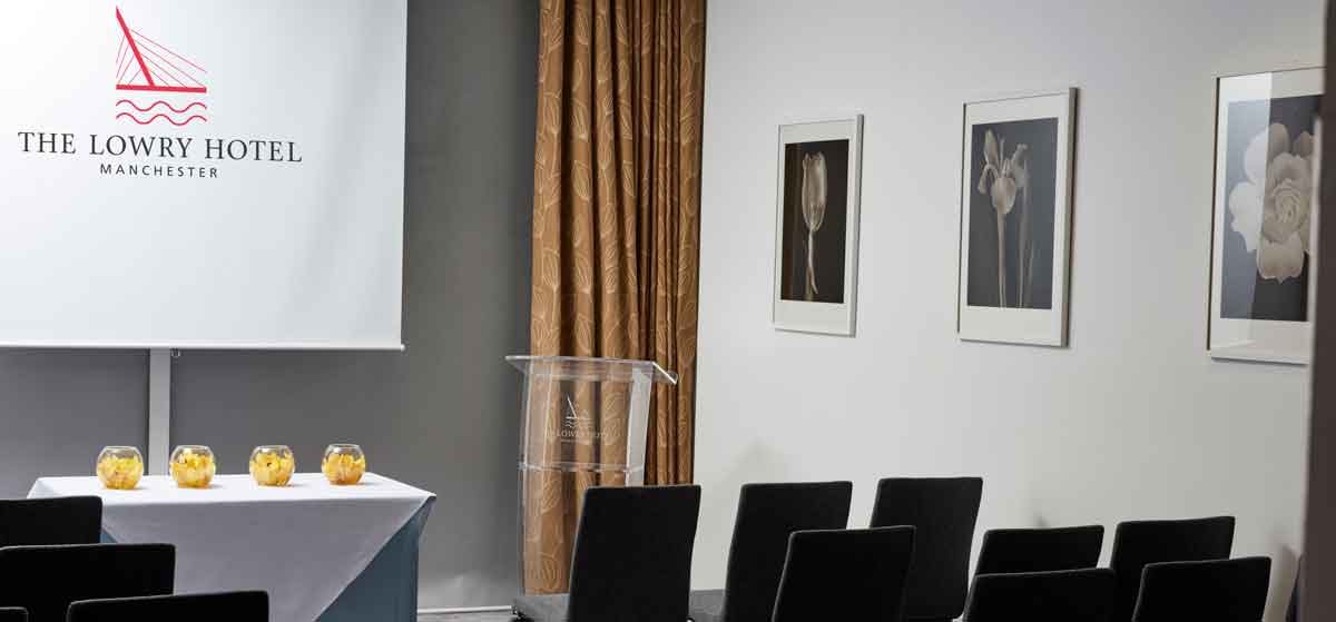 Meeting room with podium and elegant decor, ideal for professional presentations.