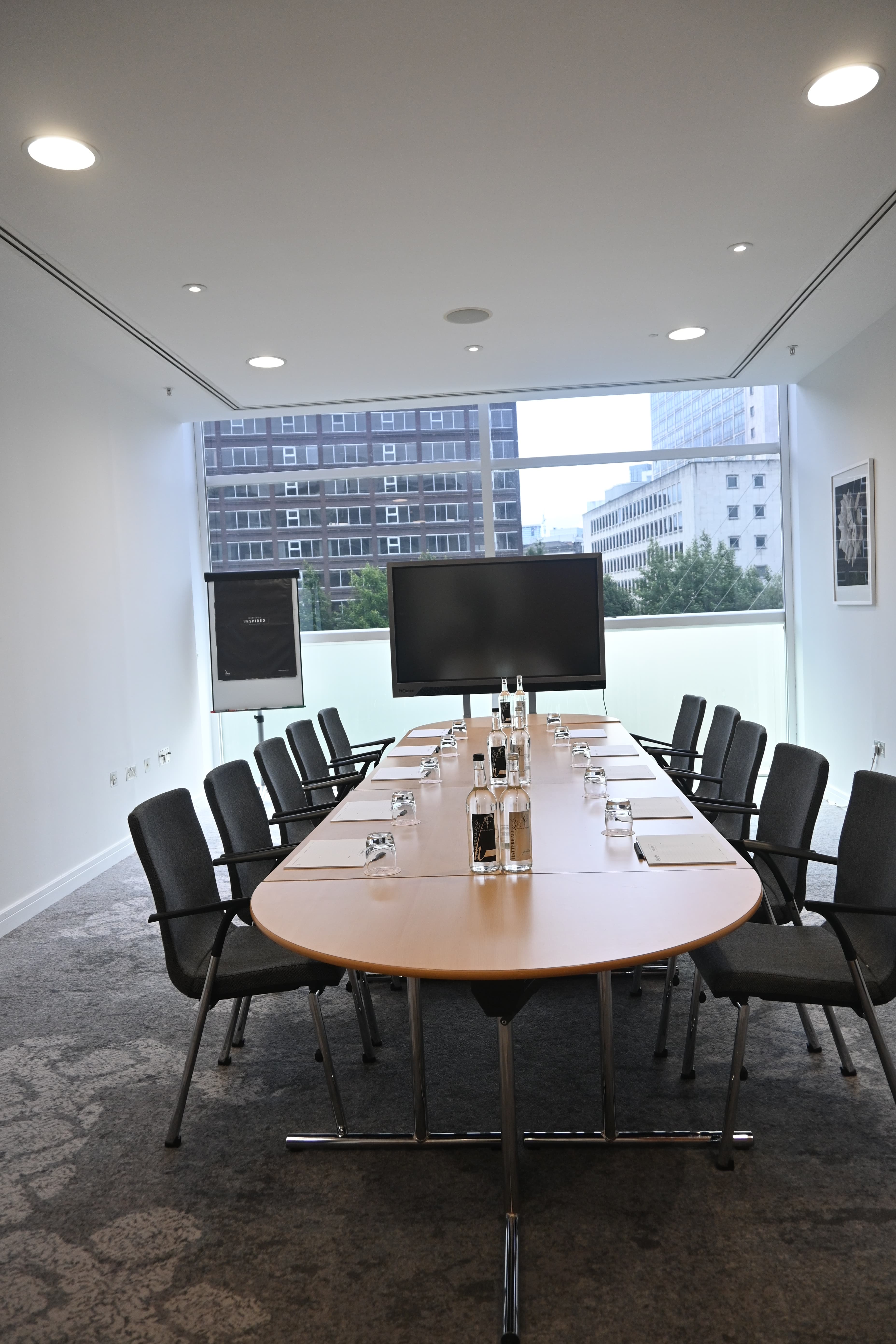 Boardroom setup in The Lowry Hotel Meeting Room 1, featuring large oval table for business events.