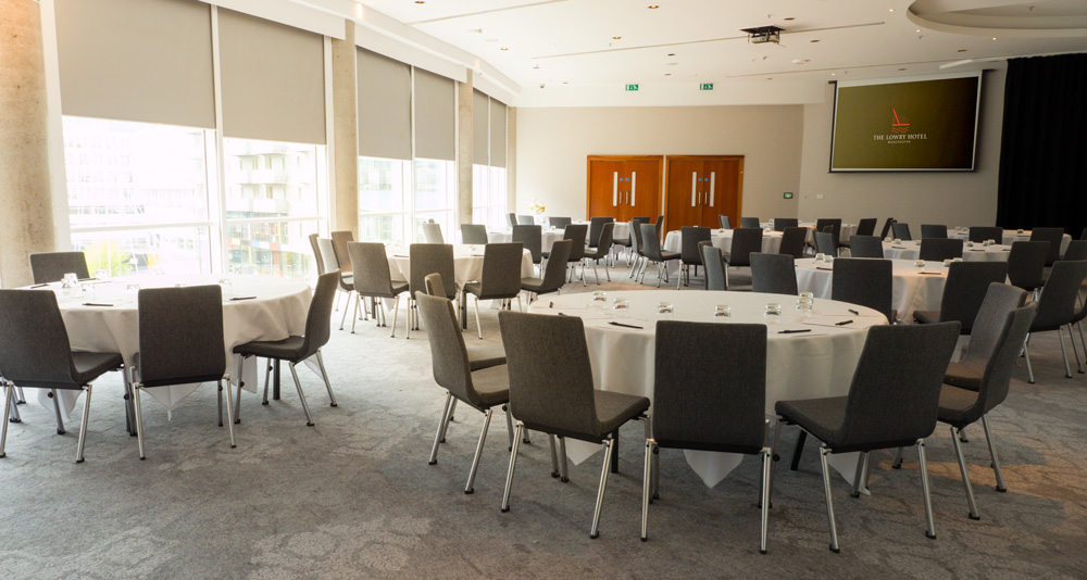 Half Ball Room at The Lowry Hotel, set for a corporate banquet with round tables.