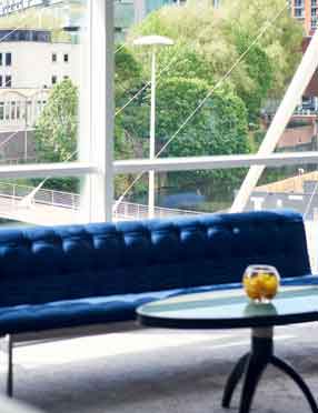 Stylish meeting space with large windows at The Lowry Hotel for events and networking.